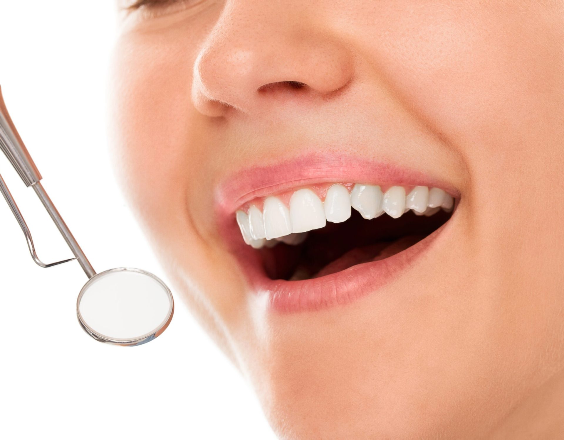 A woman is smiling while being at the dentist